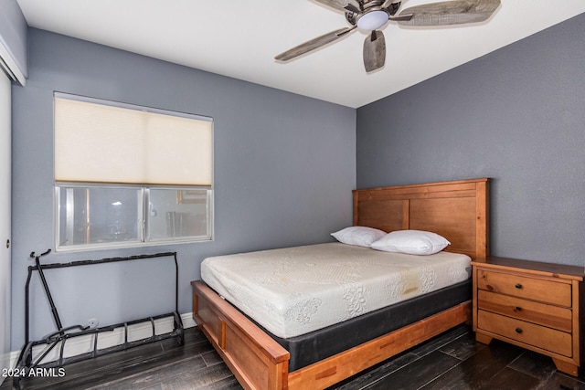 bedroom featuring ceiling fan and dark hardwood / wood-style floors