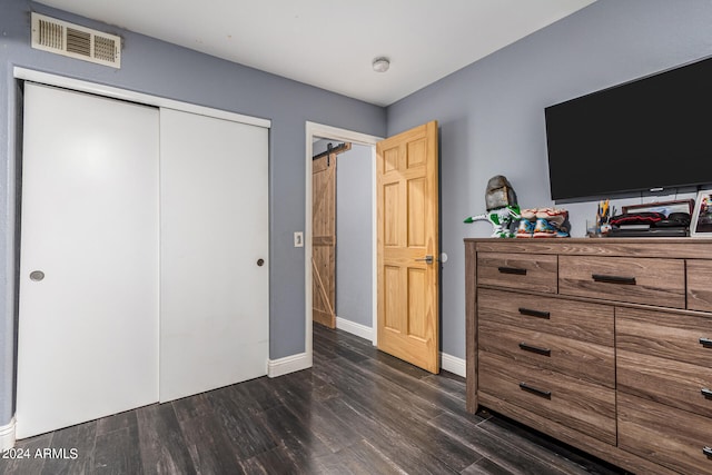 bedroom with a closet and dark hardwood / wood-style floors