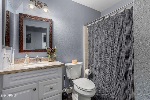 bathroom featuring vanity, toilet, and a shower with shower curtain