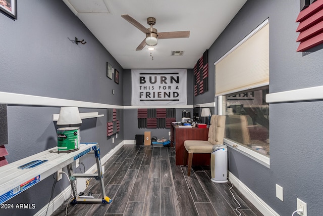 home office with ceiling fan and dark wood-type flooring