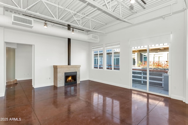 unfurnished living room with a tiled fireplace