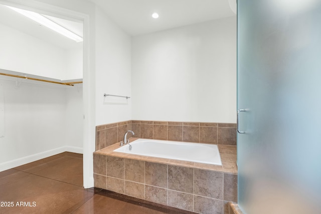 bathroom featuring tile patterned flooring and tiled tub