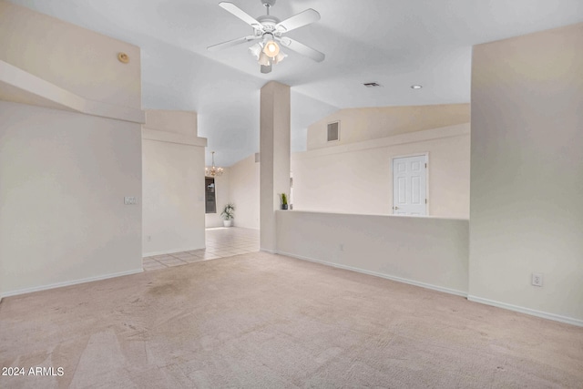 unfurnished living room with light colored carpet, ceiling fan, and lofted ceiling