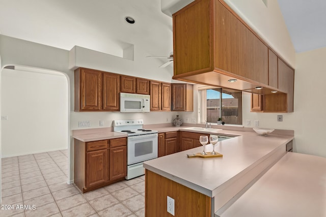 kitchen with ceiling fan, light tile floors, sink, white appliances, and kitchen peninsula