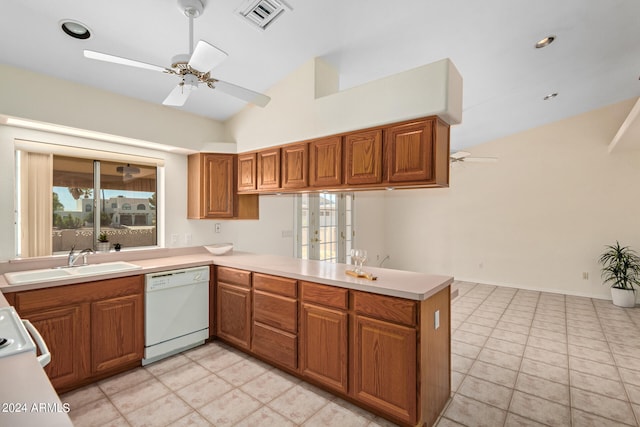 kitchen with kitchen peninsula, ceiling fan, vaulted ceiling, white dishwasher, and light tile floors