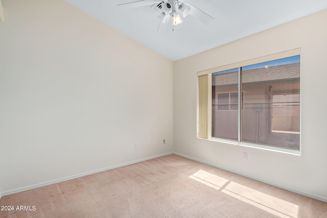 empty room featuring light colored carpet and ceiling fan