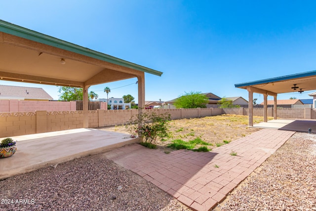 view of yard with a patio and ceiling fan