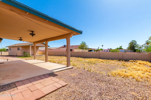 view of yard with a patio area and ceiling fan