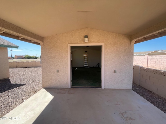 view of exterior entry with a patio