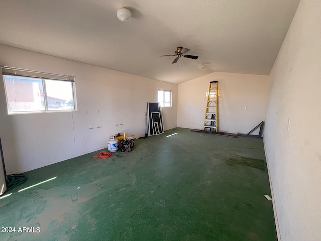 unfurnished living room featuring vaulted ceiling and ceiling fan