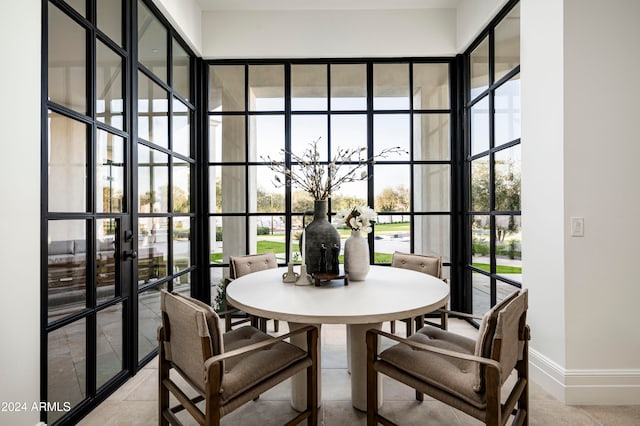 dining space featuring french doors and a healthy amount of sunlight