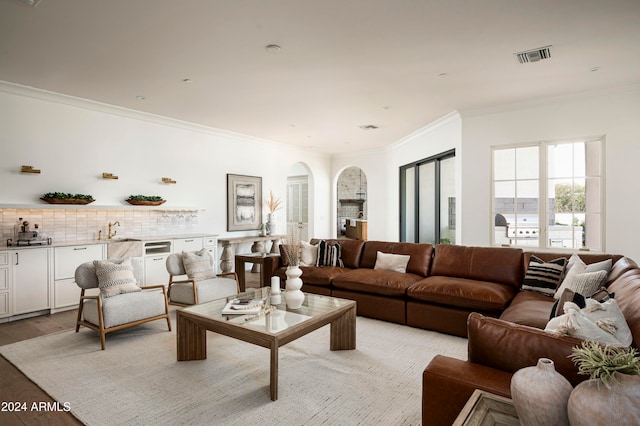 living room with light hardwood / wood-style flooring and ornamental molding