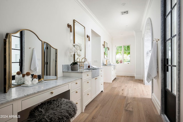 bathroom featuring vanity, wood-type flooring, and crown molding