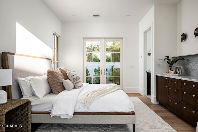 bedroom featuring light hardwood / wood-style floors and french doors