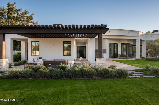 back of house with a pergola, a patio area, an outdoor living space, and a yard