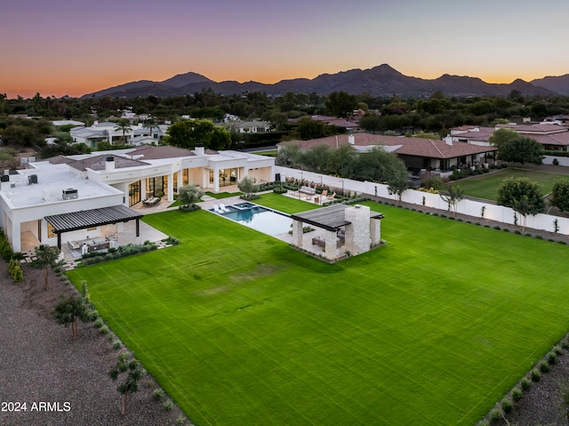 aerial view at dusk featuring a mountain view