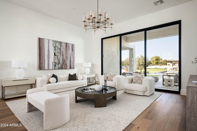 living room featuring hardwood / wood-style floors and an inviting chandelier