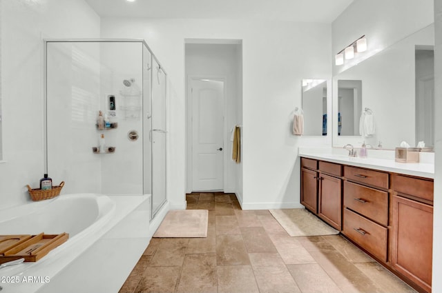 bathroom with vanity and shower with separate bathtub