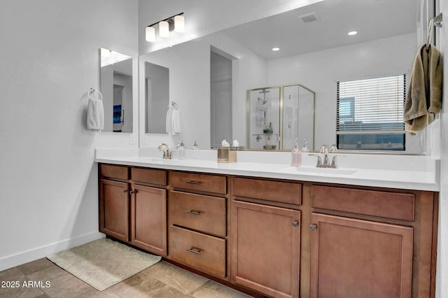 bathroom with vanity and a shower with shower door