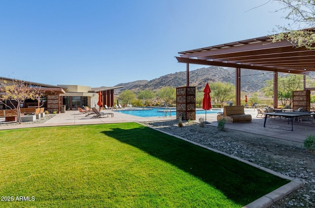 view of yard featuring a patio, a mountain view, and a community pool