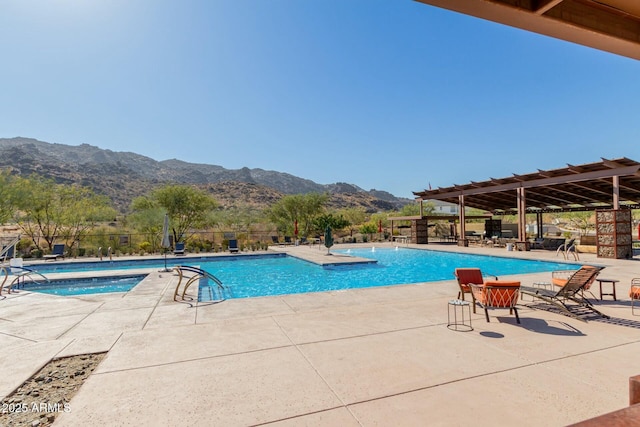 view of pool with a patio and a mountain view