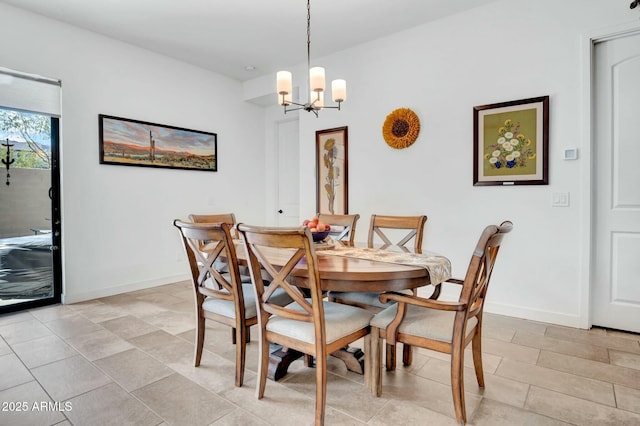 dining area with an inviting chandelier