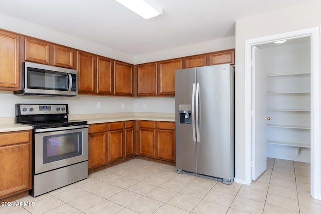 kitchen featuring stainless steel appliances and light tile patterned floors