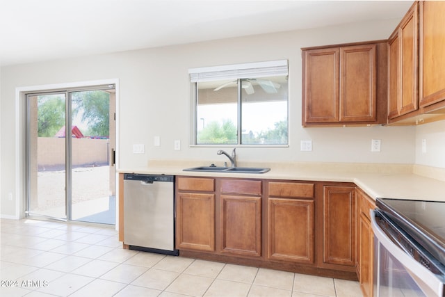 kitchen featuring light tile patterned floors, sink, ceiling fan, and stainless steel appliances