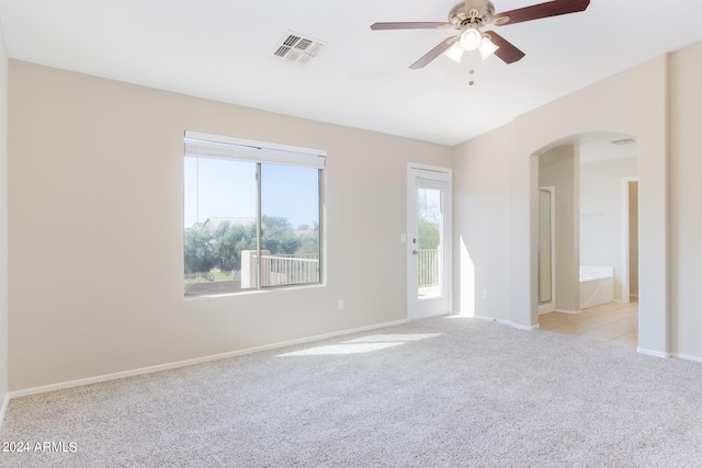 empty room with ceiling fan and light colored carpet