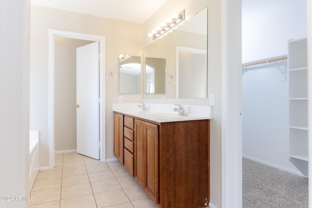 bathroom with tile patterned floors, vanity, and a bathtub