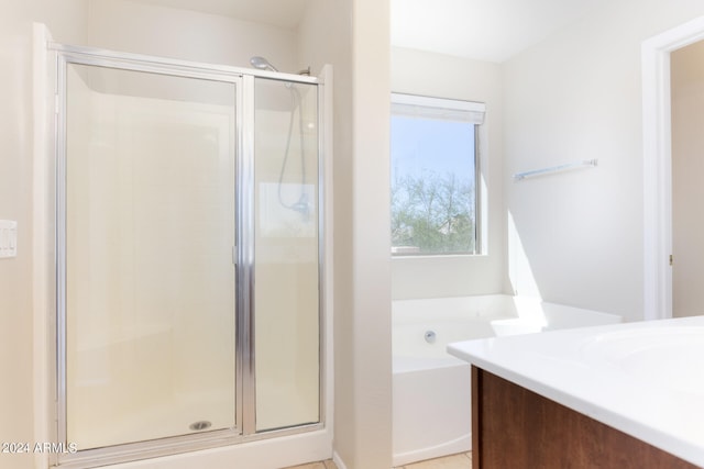 bathroom featuring shower with separate bathtub and vanity