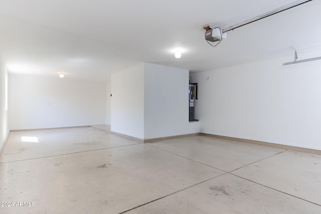 garage featuring strapped water heater and a garage door opener