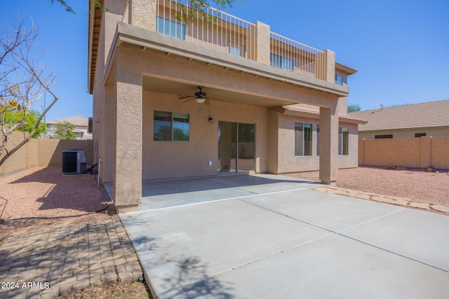 back of property with a balcony, ceiling fan, central AC, and a patio area