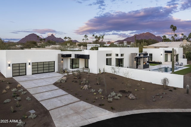 contemporary house featuring a mountain view and a garage