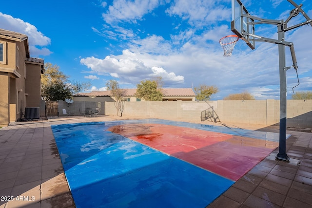 view of swimming pool featuring basketball court and central air condition unit