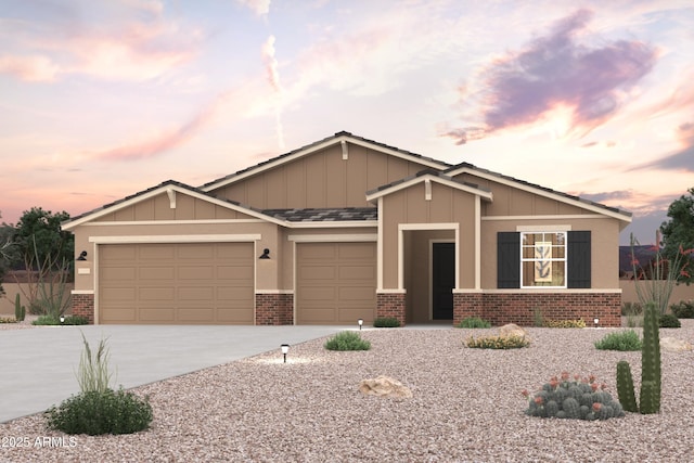 craftsman house featuring brick siding, an attached garage, driveway, and board and batten siding