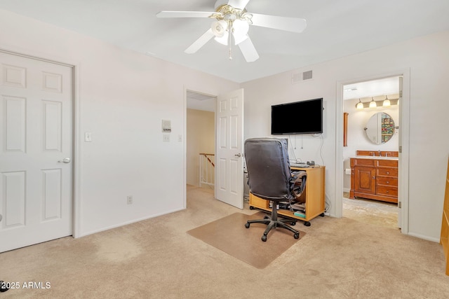 office space featuring light carpet and ceiling fan