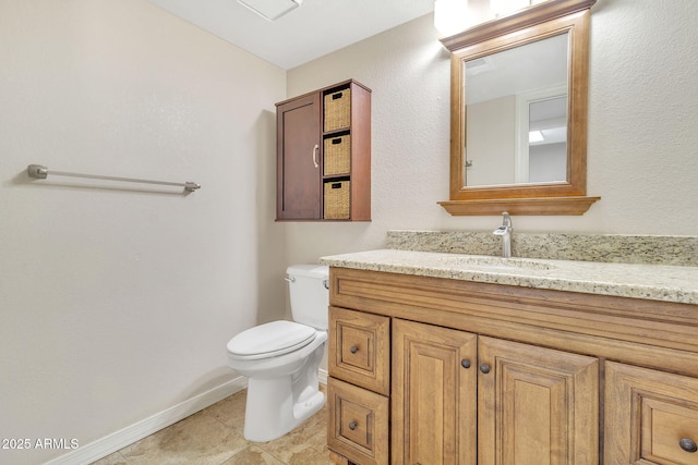 bathroom with vanity, tile patterned floors, and toilet