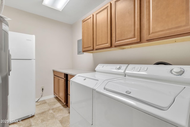 laundry room with cabinets and washer and clothes dryer