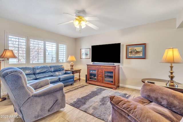 living room featuring a wealth of natural light and ceiling fan