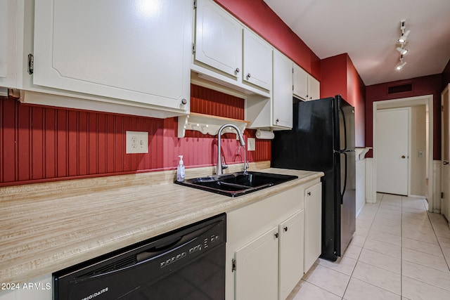 kitchen with light tile patterned flooring, sink, white cabinetry, and black appliances