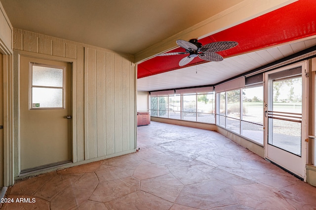 unfurnished sunroom with ceiling fan