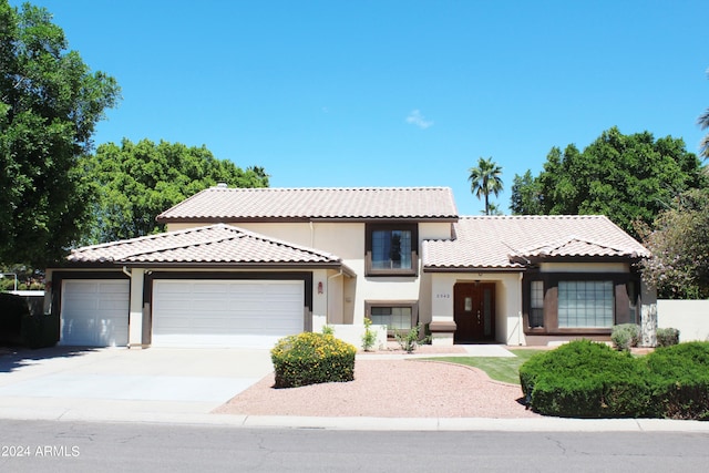 mediterranean / spanish house featuring a garage