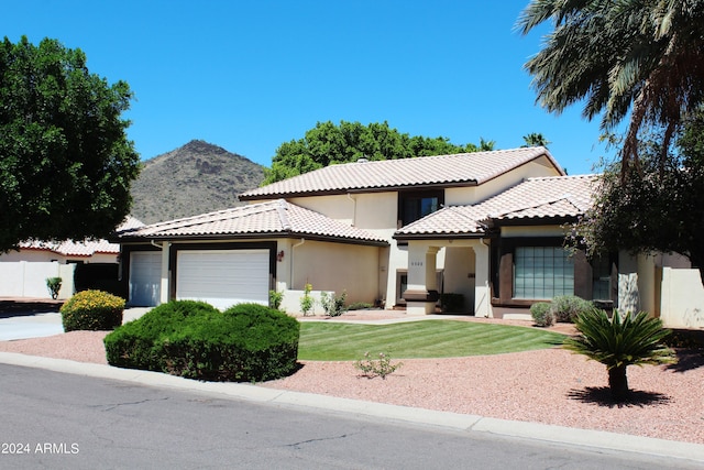 view of front facade featuring a garage and a front lawn