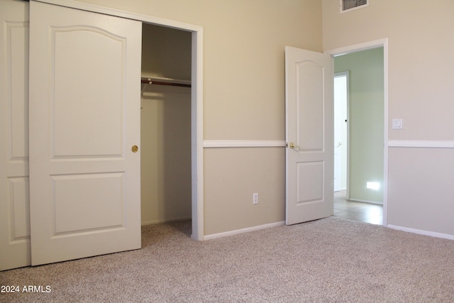 unfurnished bedroom with a closet and carpet floors