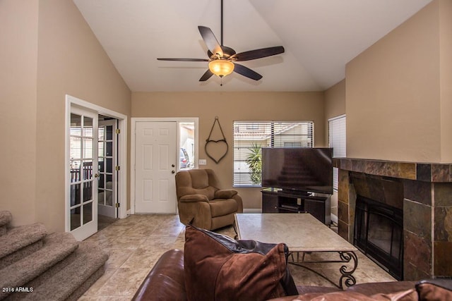 living room featuring ceiling fan, lofted ceiling, and a fireplace