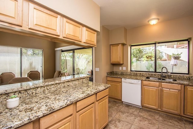 kitchen with sink, white dishwasher, light stone counters, and light brown cabinets