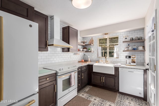 kitchen with open shelves, white appliances, a sink, backsplash, and wall chimney exhaust hood