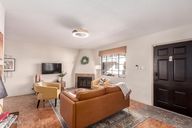 living room featuring a fireplace and baseboards