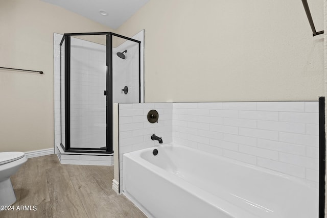 bathroom featuring toilet, wood-type flooring, and shower with separate bathtub